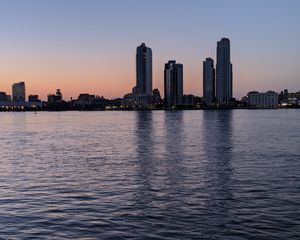 Preview wallpaper city, skyscrapers, buildings, water, evening