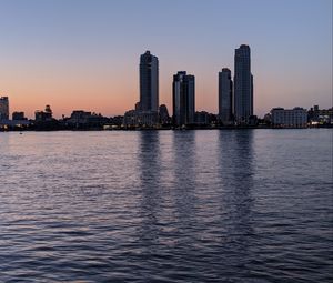 Preview wallpaper city, skyscrapers, buildings, water, evening