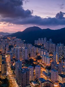 Preview wallpaper city, skyscrapers, buildings, evening, mountains