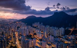 Preview wallpaper city, skyscrapers, buildings, evening, mountains