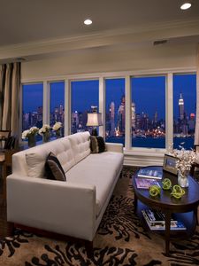 Preview wallpaper city, sofa, buildings, interiors, apartment, room, suite, metropolis, skyscrapers, night, new york, window, penthouse, table, usa