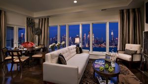 Preview wallpaper city, sofa, buildings, interiors, apartment, room, suite, metropolis, skyscrapers, night, new york, window, penthouse, table, usa