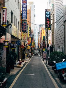Preview wallpaper city, street, buildings, hieroglyphs, road