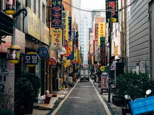 Preview wallpaper city, street, buildings, hieroglyphs, road