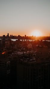 Preview wallpaper city, sunset, aerial view, buildings, sun