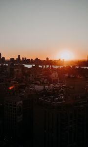 Preview wallpaper city, sunset, aerial view, buildings, sun