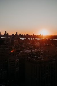 Preview wallpaper city, sunset, aerial view, buildings, sun
