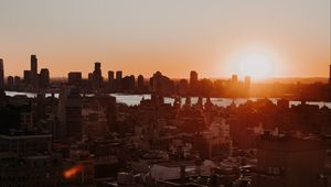 Preview wallpaper city, sunset, aerial view, buildings, sun
