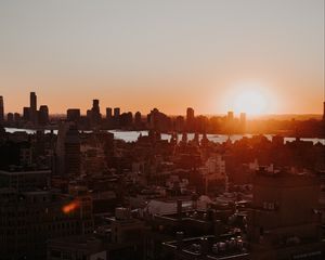 Preview wallpaper city, sunset, aerial view, buildings, sun