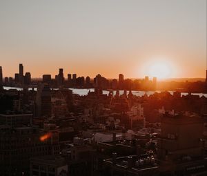 Preview wallpaper city, sunset, aerial view, buildings, sun