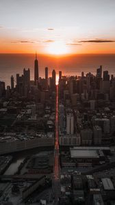 Preview wallpaper city, sunset, aerial view, buildings, sea, coast