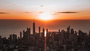 Preview wallpaper city, sunset, aerial view, buildings, sea, coast