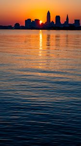 Preview wallpaper city, sunset, coast, water, dark