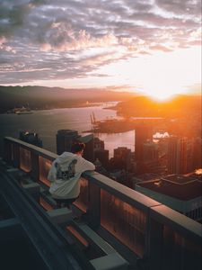 Preview wallpaper city, sunset, loneliness, man, solitude