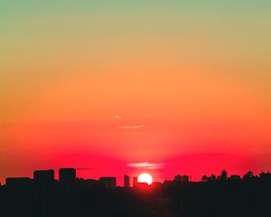 Preview wallpaper city, sunset, sky, horizon, sun