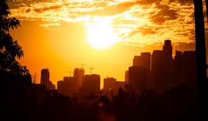 Preview wallpaper city, sunset, sun, buildings, twilight