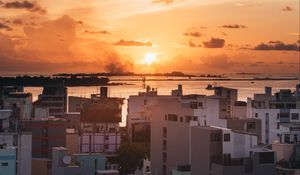 Preview wallpaper city, sunset, sun, evening