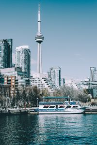 Preview wallpaper city, tower, buildings, boat, pier, water