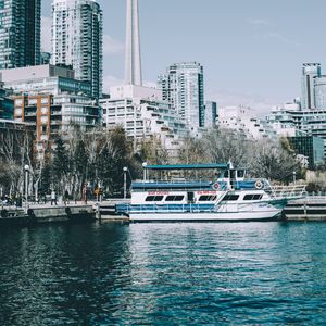 Preview wallpaper city, tower, buildings, boat, pier, water