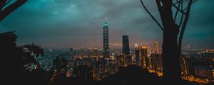 Preview wallpaper city, tower, cityscape, evening, lights, thunderclouds