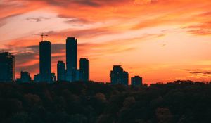 Preview wallpaper city, tower, sunset, road, trees
