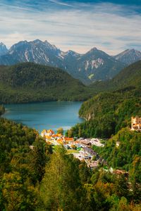 Preview wallpaper city, trees, forest, lake, mountains, clouds, sky, landscape