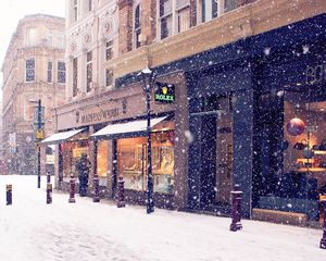 Preview wallpaper city, winter, europe, street, snow, shopping