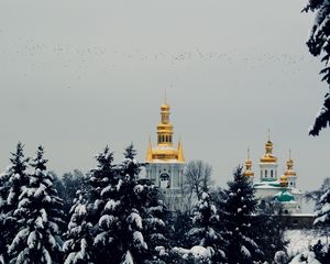 Preview wallpaper city, winter, snow, church, trees, pine trees, sky, flying, birds, mood