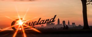 Preview wallpaper cleveland, night city, sunset, silhouettes, inscription, sunlight