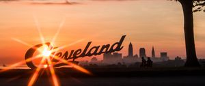 Preview wallpaper cleveland, night city, sunset, silhouettes, inscription, sunlight