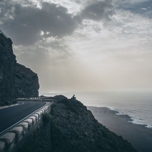 Preview wallpaper cliff, coast, silhouette, sea, road