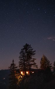 Preview wallpaper cliff, house, night, mountains, starry sky, light