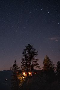 Preview wallpaper cliff, house, night, mountains, starry sky, light