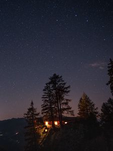 Preview wallpaper cliff, house, night, mountains, starry sky, light