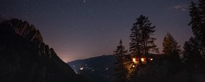 Preview wallpaper cliff, house, night, mountains, starry sky, light