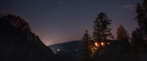 Preview wallpaper cliff, house, night, mountains, starry sky, light