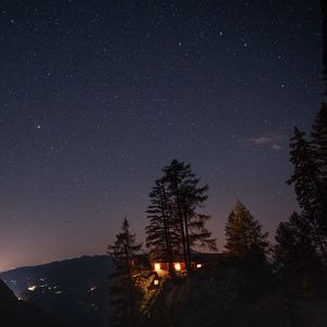 Preview wallpaper cliff, house, night, mountains, starry sky, light