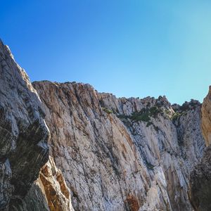 Preview wallpaper cliff, mountains, rocks, lake, sky