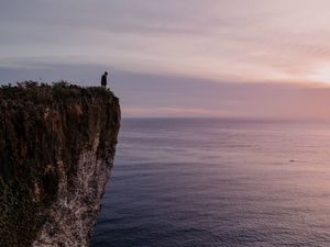 Preview wallpaper cliff, person, alone, sea, shore