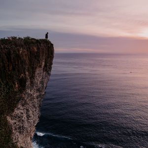 Preview wallpaper cliff, person, alone, sea, shore
