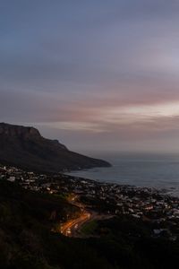 Preview wallpaper cliff, road, buildings, coast, dusk