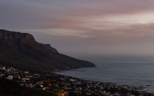 Preview wallpaper cliff, road, buildings, coast, dusk