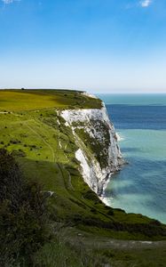 Preview wallpaper cliff, rock, coast, grass, sea