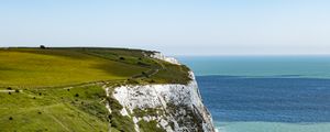 Preview wallpaper cliff, rock, coast, grass, sea