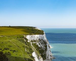 Preview wallpaper cliff, rock, coast, grass, sea