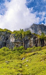 Preview wallpaper cliff, rock, grass, clouds