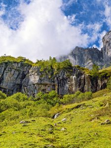 Preview wallpaper cliff, rock, grass, clouds