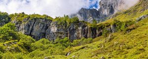 Preview wallpaper cliff, rock, grass, clouds