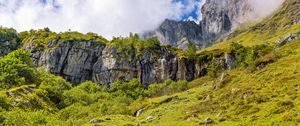 Preview wallpaper cliff, rock, grass, clouds