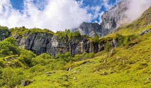 Preview wallpaper cliff, rock, grass, clouds